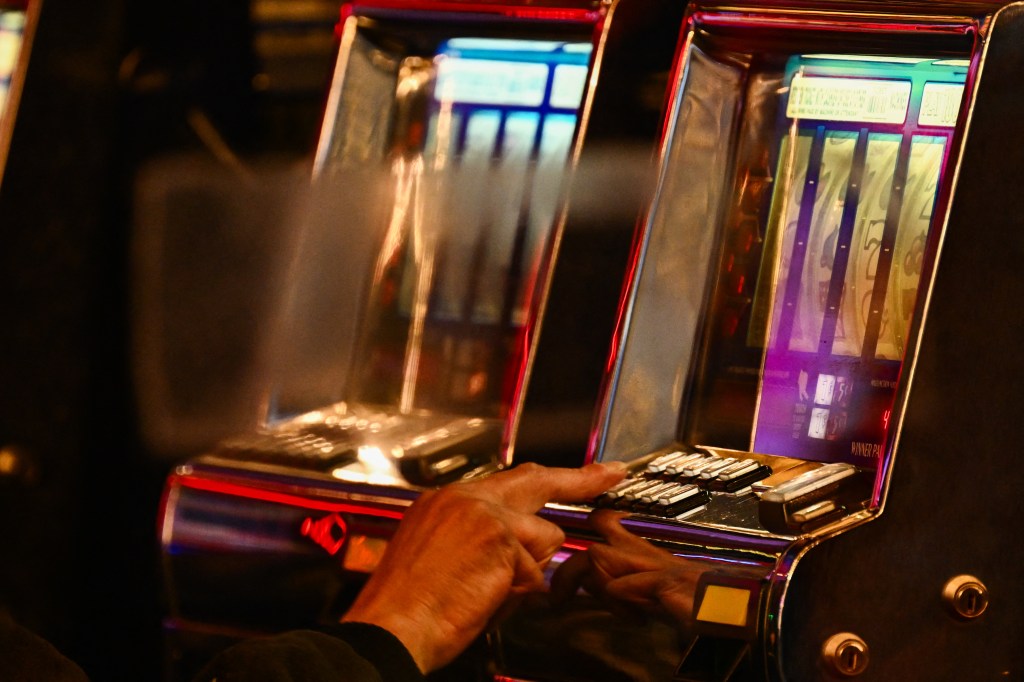 A customer uses a slot machine inside a casino in downtown Las Vegas, Nevada ahead of the Super Bowl and a potential strike by kitchen workers and bartenders unions